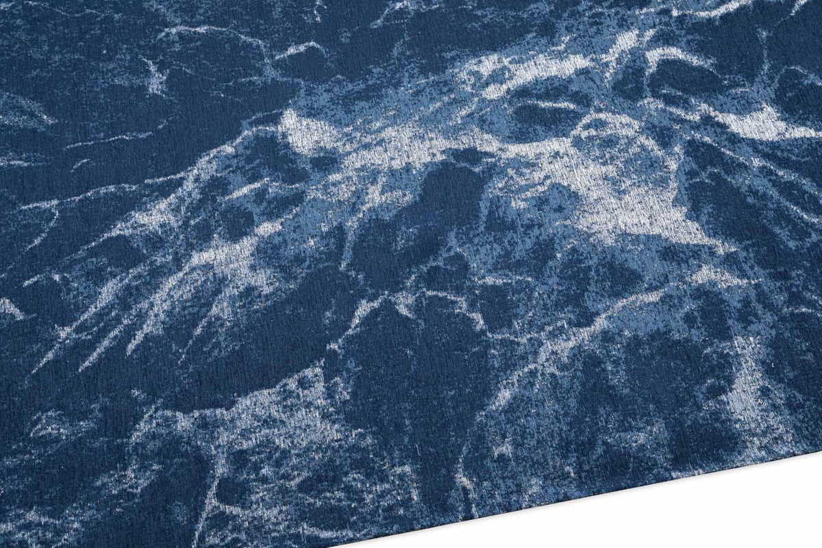 Nowoczesny dywan Atlantic Blue z abstrakcyjnym, marmurkowym wzorem w odcieniach granatu i bieli.